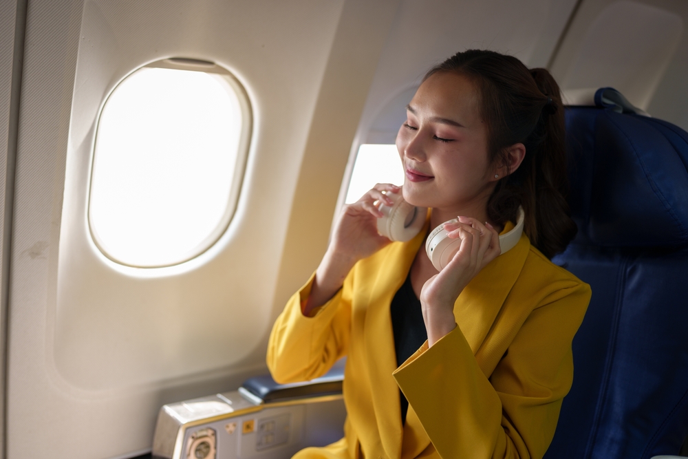 Passenger on a plane with headphones